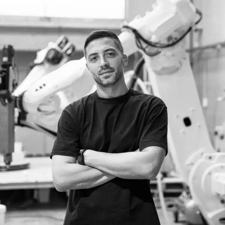 Aldo Sollazzo photographed in a robotics workspace